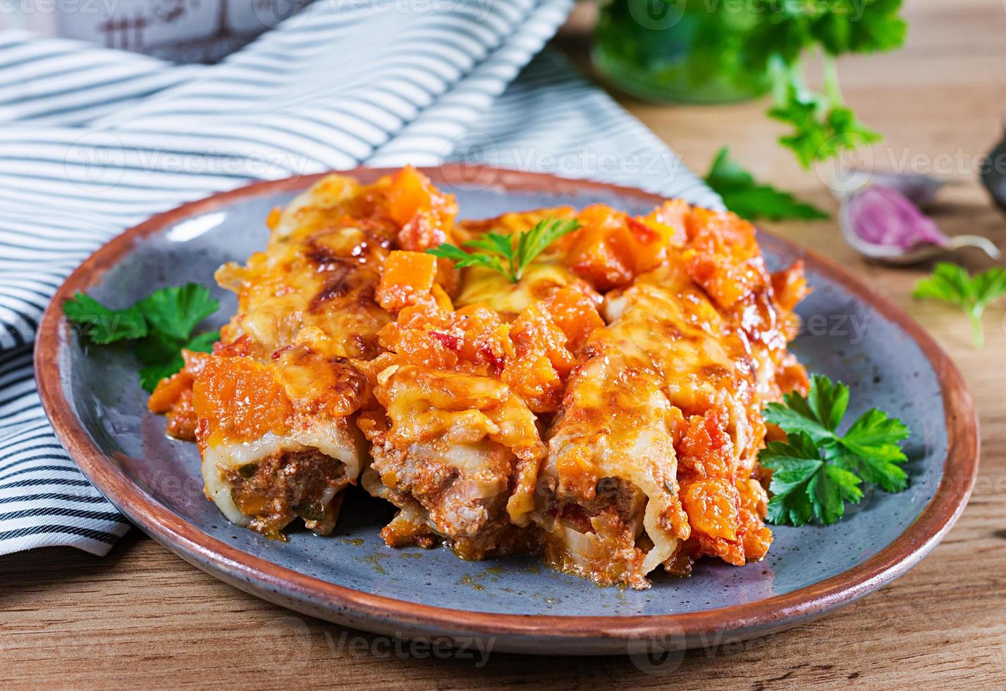 Meat cannelloni pumpkin-tomato sauce on plate. photo