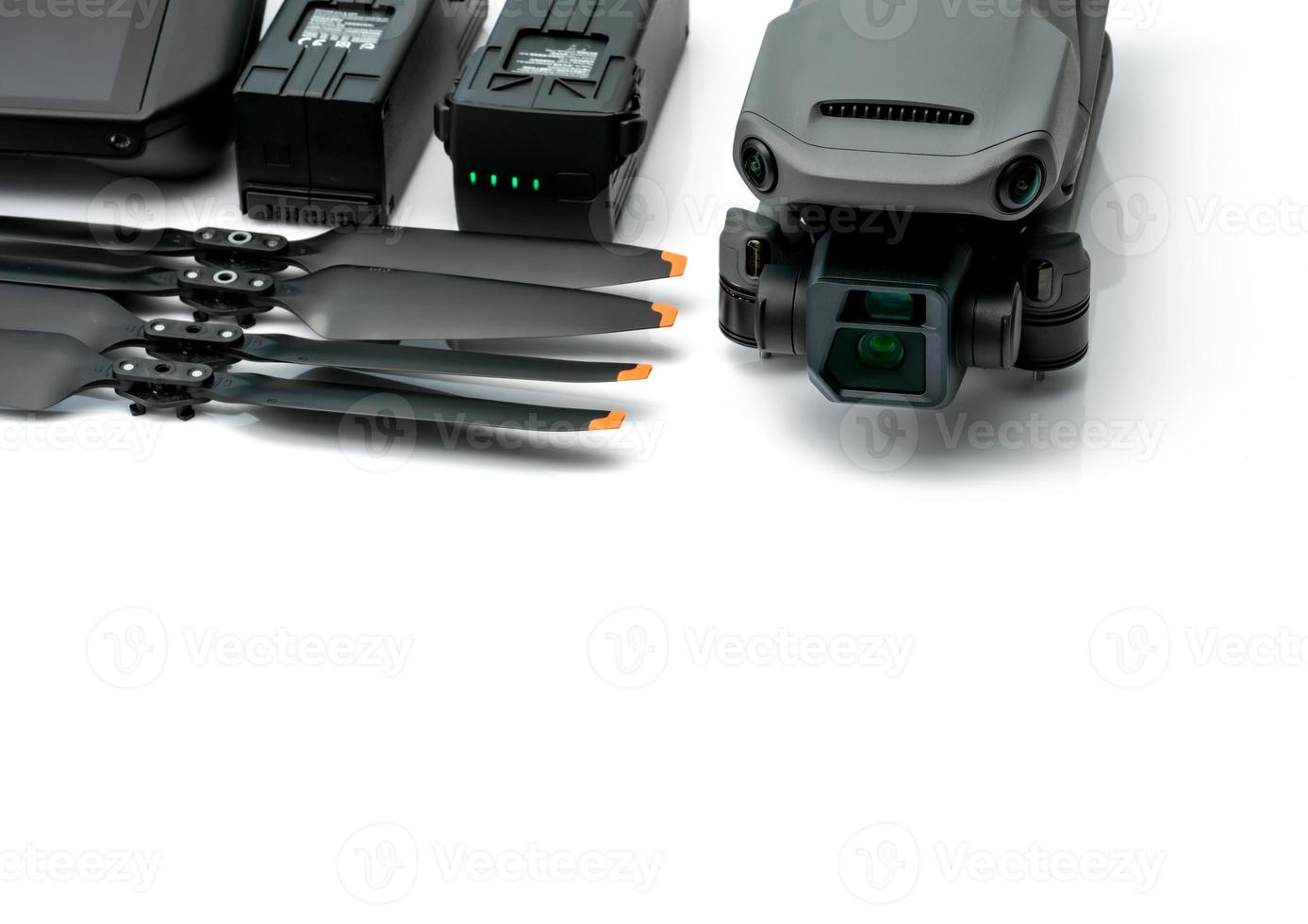 Drone and propeller blades on blur drone LiPo rechargeable battery. UAV or unmanned aerial vehicle. Quadcopter drone aircraft with a digital camera. Drone accessories. UAV carbon fiber propellers. photo