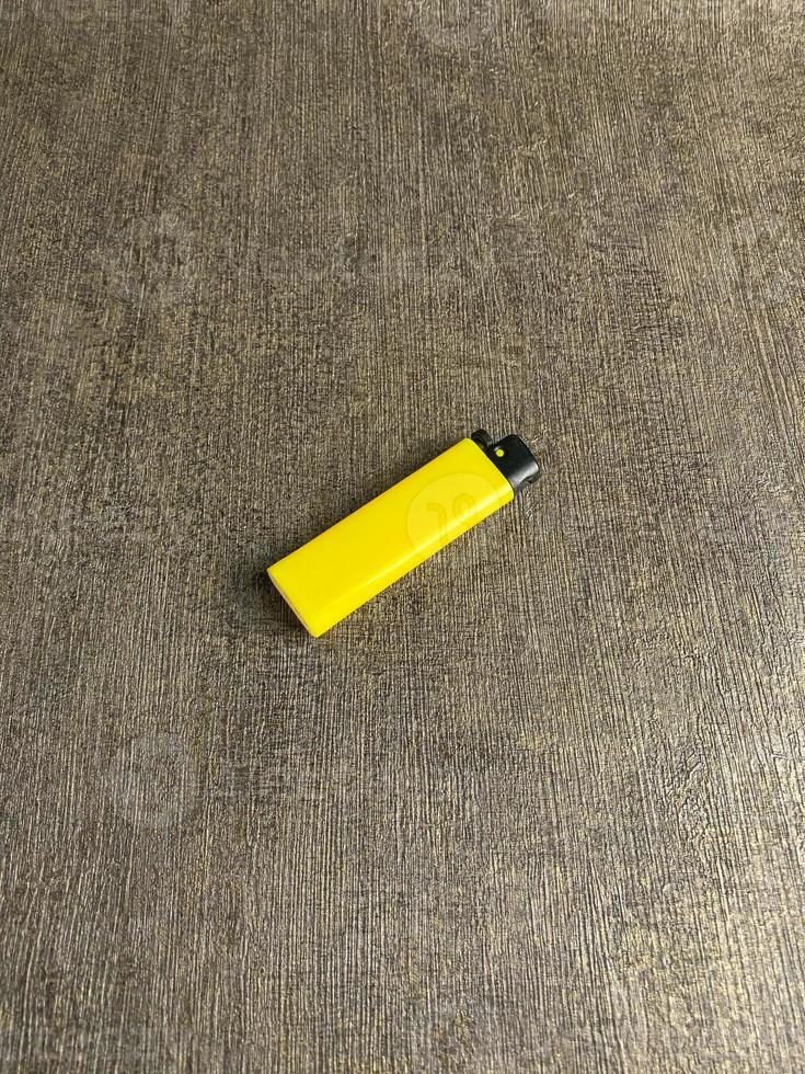 yellow lighter isolated on white background. hand tried to lit yellow lighter. copy space. selected focus photo