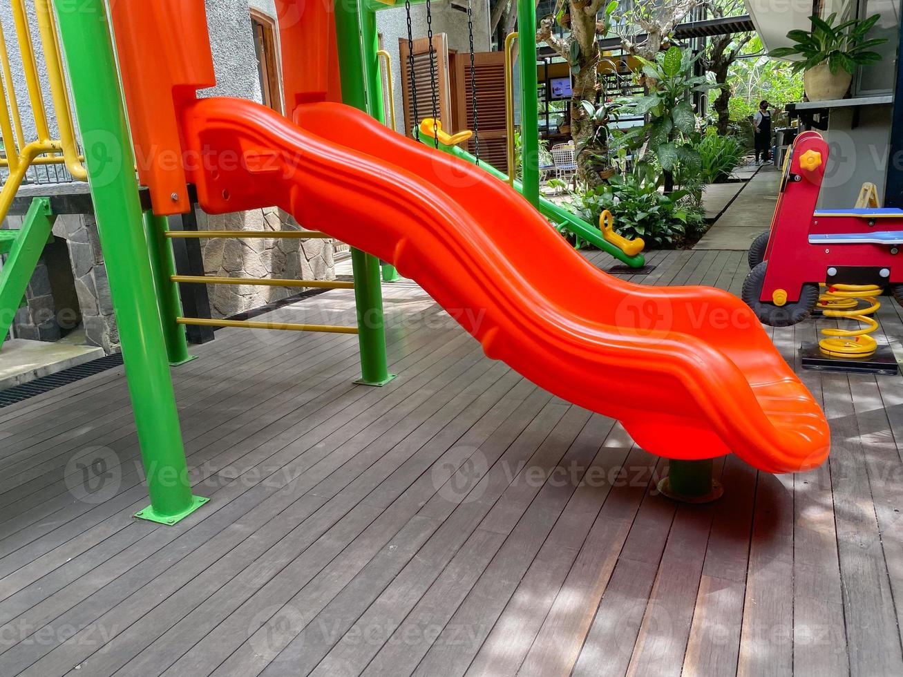 Colorful playground made of plastic empty outdoor playground set playground equipment.Garden equipment. Children's slide. School yard. Playground in the park. photo