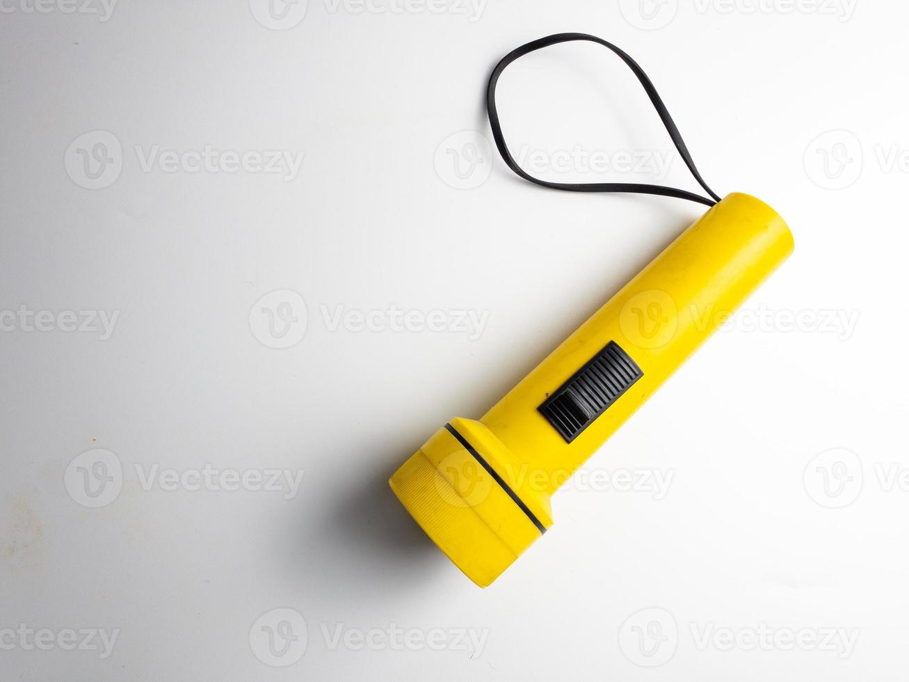 yellow flashlight on white background. copy space. flashlight for blackout and emergency. selected focus photo