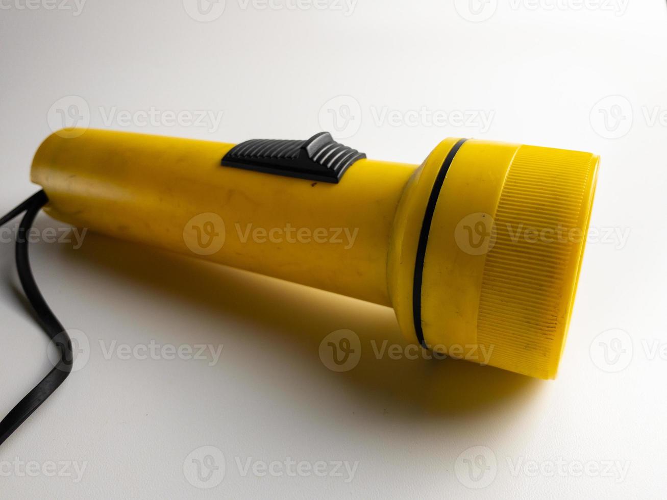 yellow flashlight on white background. copy space. flashlight for blackout and emergency. selected focus photo