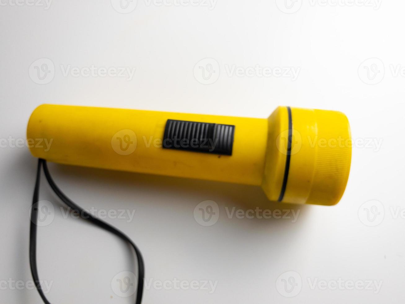 yellow flashlight on white background. copy space. flashlight for blackout and emergency. selected focus photo