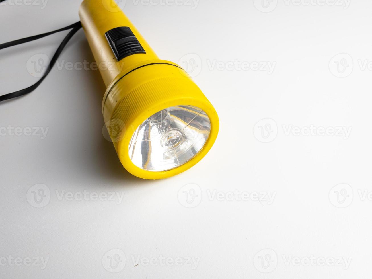 yellow flashlight on white background. copy space. flashlight for blackout and emergency. selected focus photo