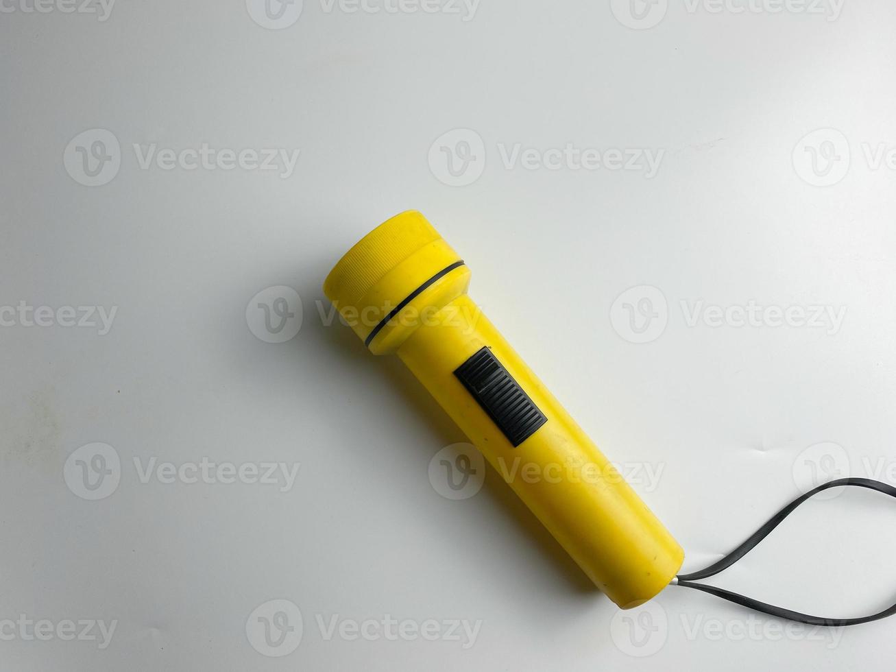 yellow flashlight on white background. copy space. flashlight for blackout and emergency. selected focus photo