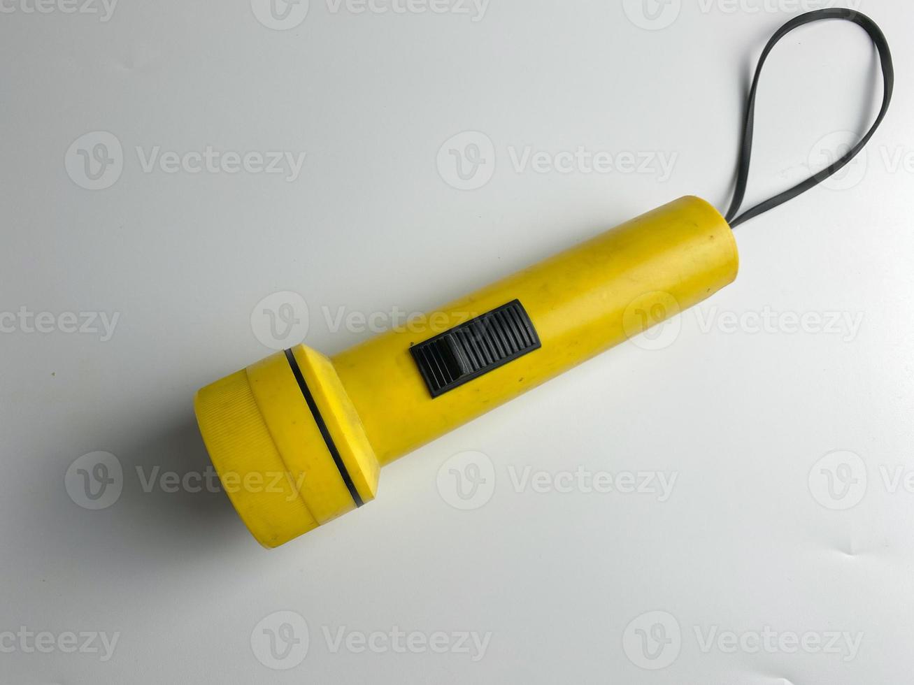 yellow flashlight on white background. copy space. flashlight for blackout and emergency. selected focus photo