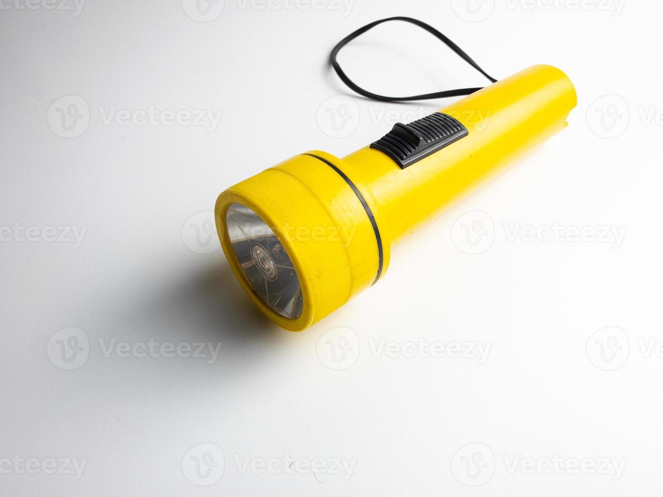yellow flashlight on white background. copy space. flashlight for blackout and emergency. selected focus photo