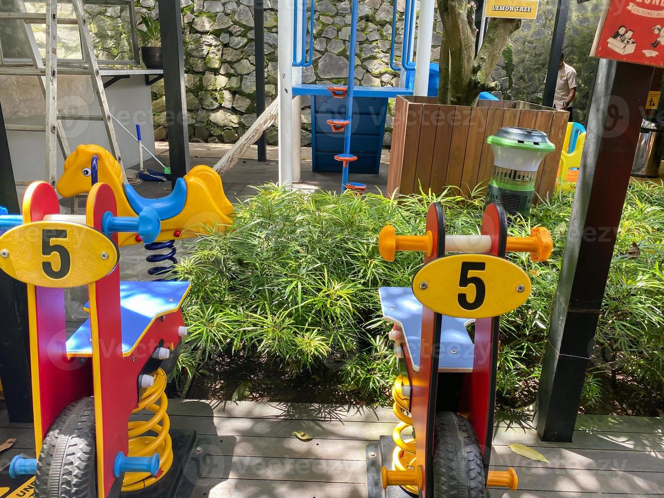 Colorful playground made of plastic empty outdoor playground set playground equipment.Garden equipment. Children's slide. School yard. Playground in the park. photo