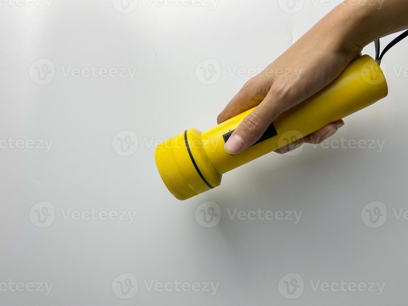 yellow flashlight on white background. copy space. flashlight for blackout and emergency. selected focus photo