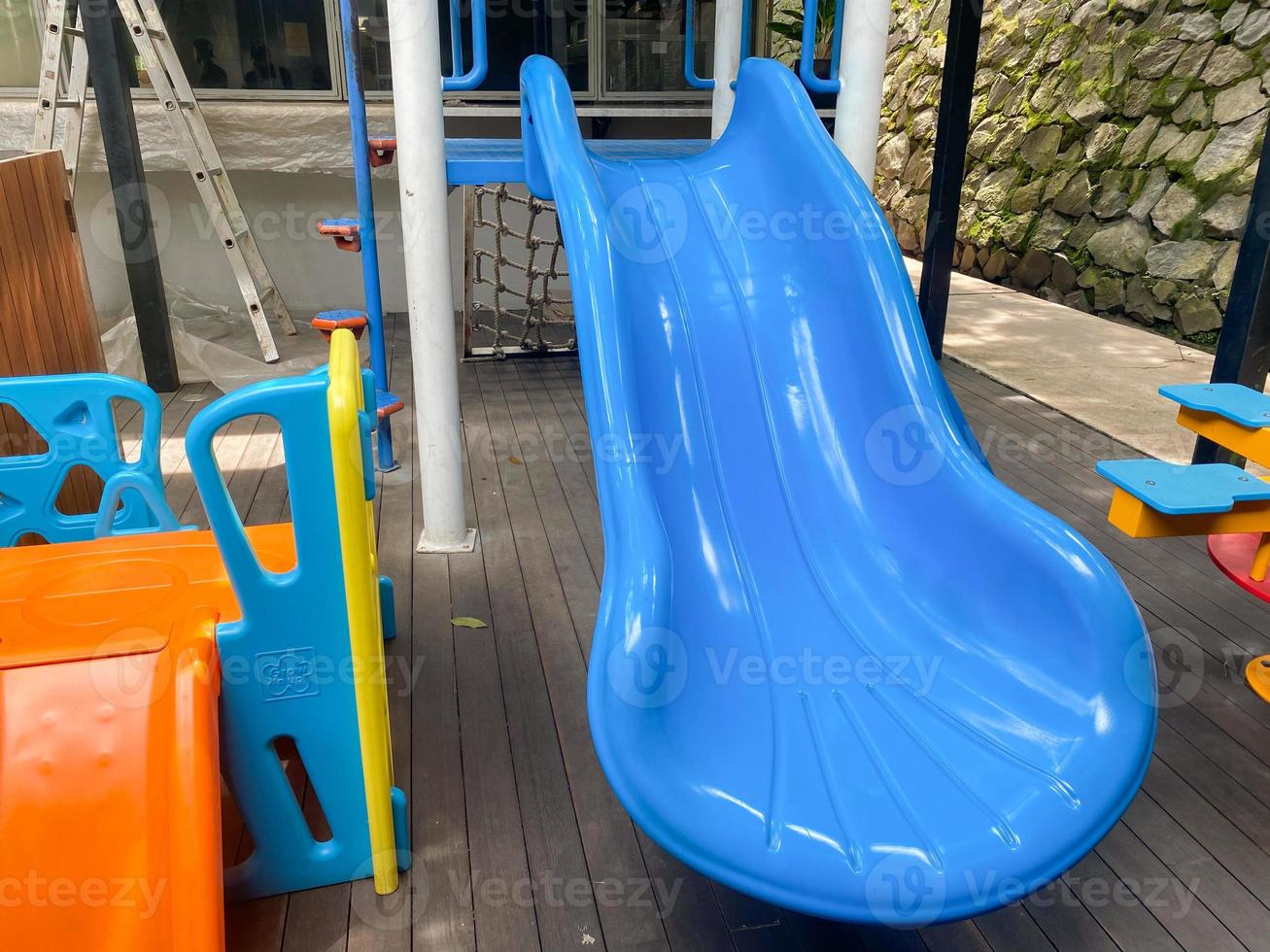 Colorful playground made of plastic empty outdoor playground set playground equipment.Garden equipment. Children's slide. School yard. Playground in the park. photo