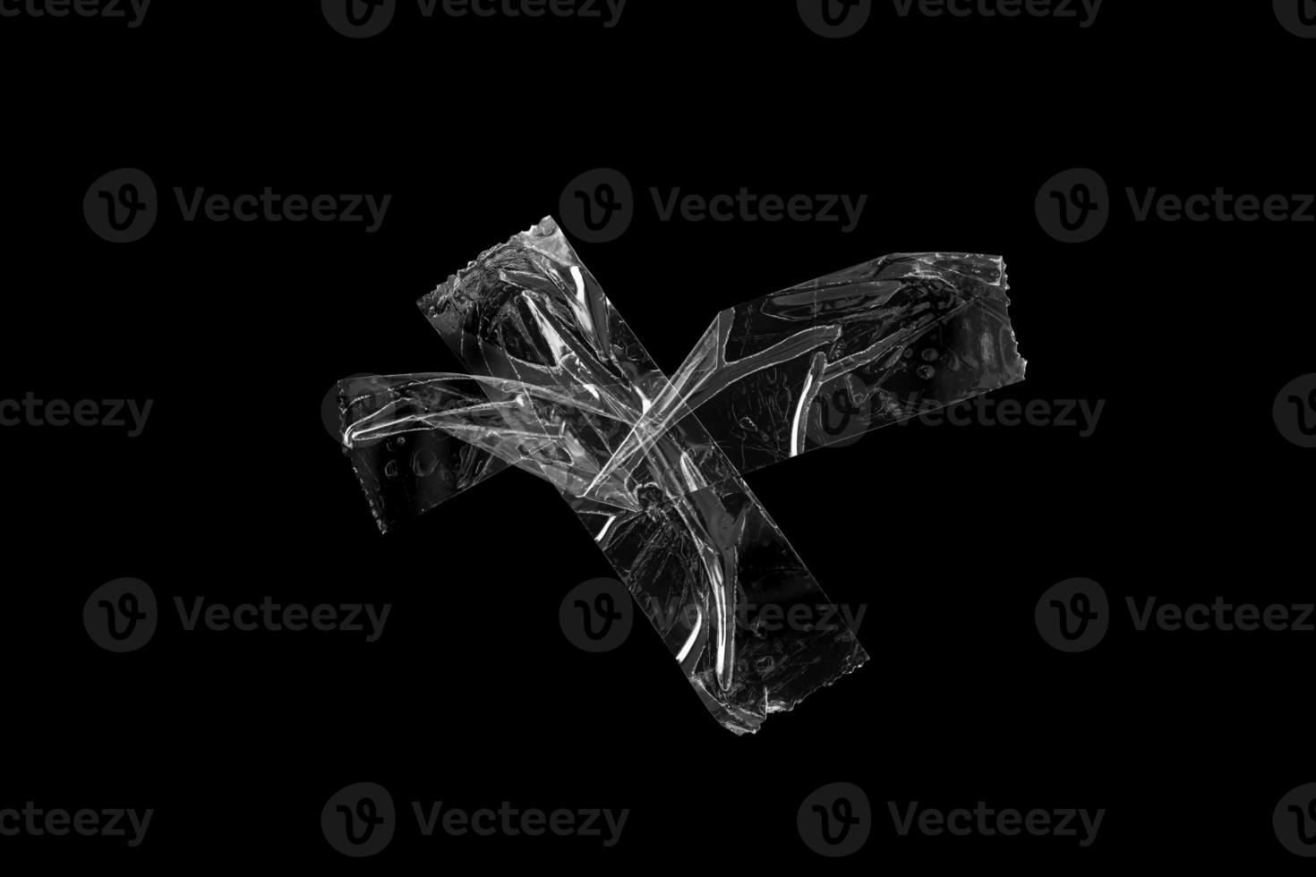 adhesive plastic tape isolated on black background photo