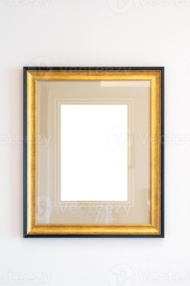 Blank golden vintage wood picture photo frame on white wall background