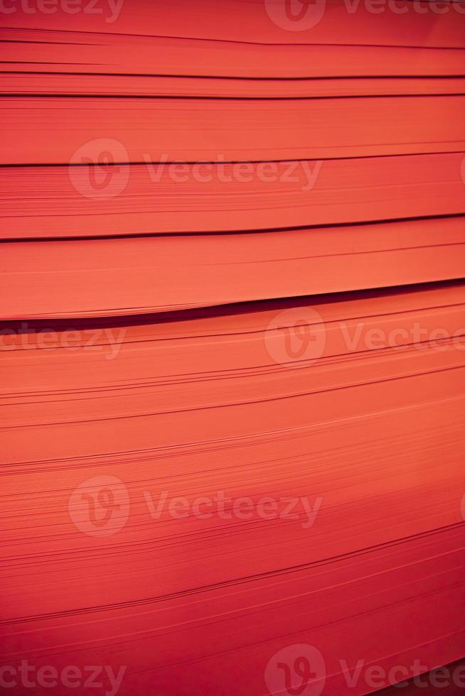 abstract background of red paper sheets, close up, vertical image photo