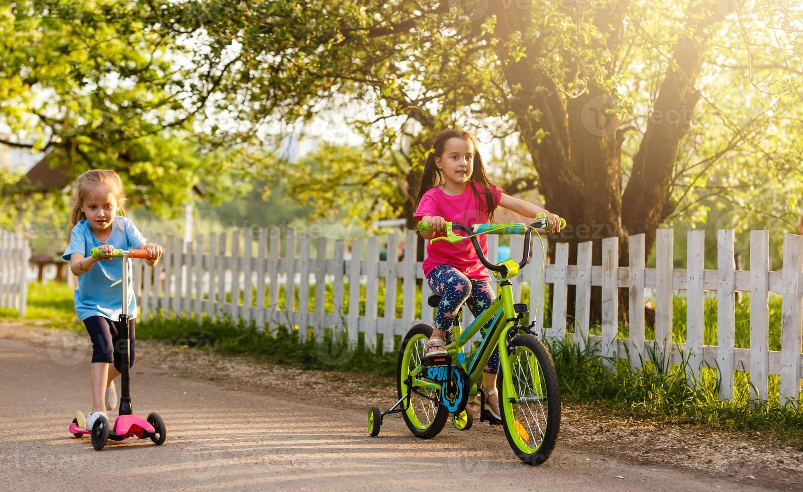 Little girl riding bicycle in city park. photo