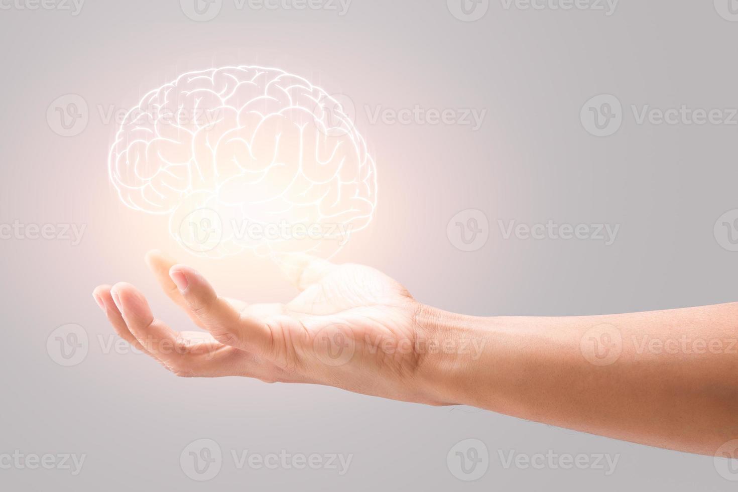 Mental health. Man holding brain illustration against gray wall background. photo