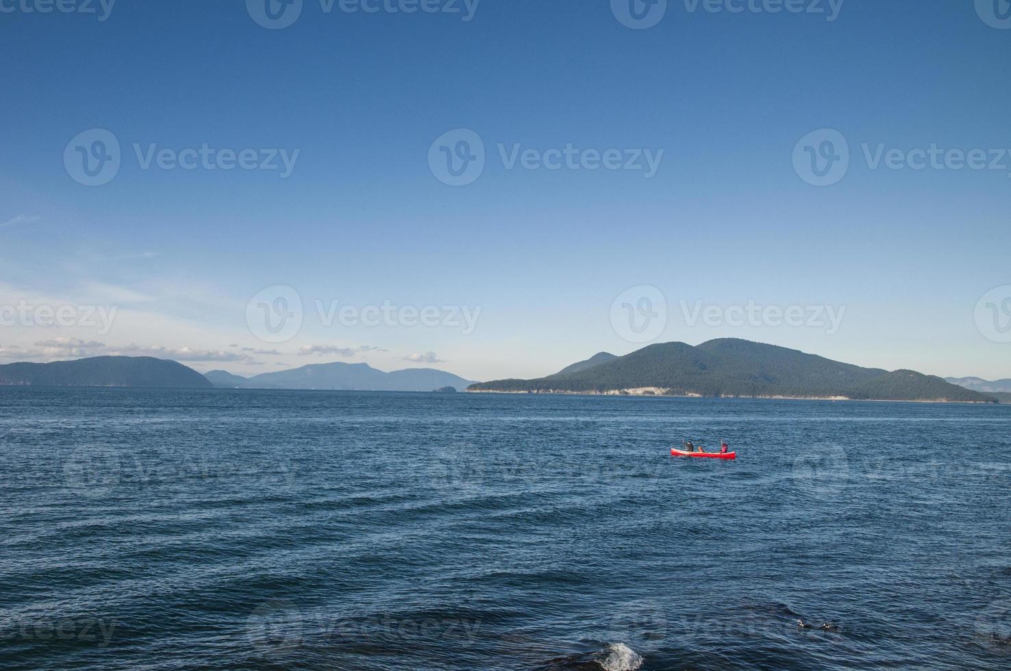 Rowing a red boat on a windy day photo