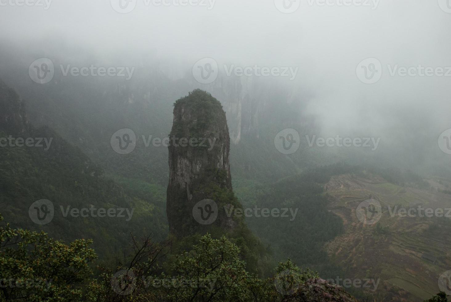 Mountain peak with a very interesting shape in fogs photo
