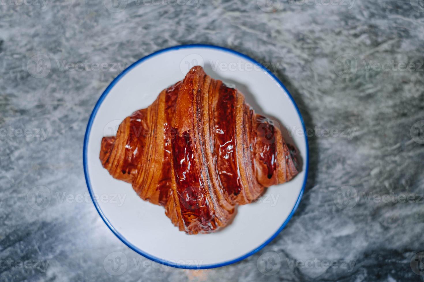 Croissant in a white small plate photo