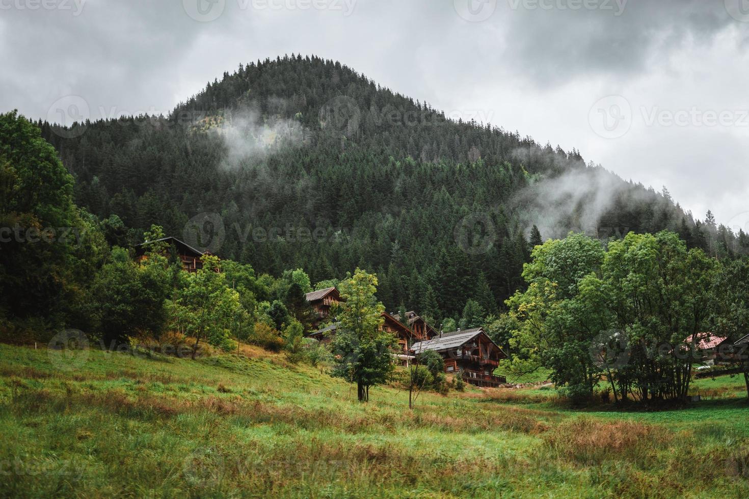 Wooden hut in the alps with mountains in the background Panorama photo