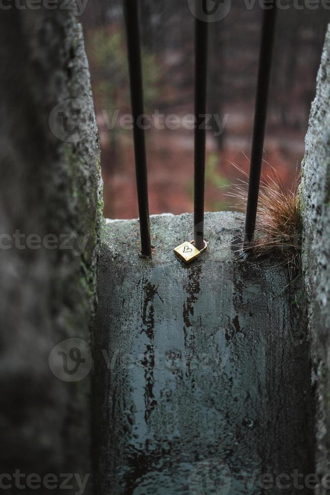 Love lock laying on the ground with a heart on it and rain photo