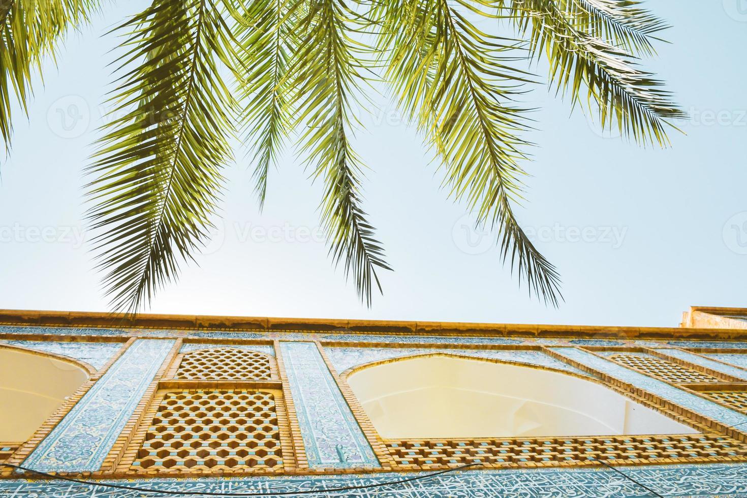 Shiraz, Iran - june 6th, 2022 - Khan school.Persian courtyard with green garden at Madrese e-Khan. The ancient religious school is a popular tourist attraction of the Middle East. photo