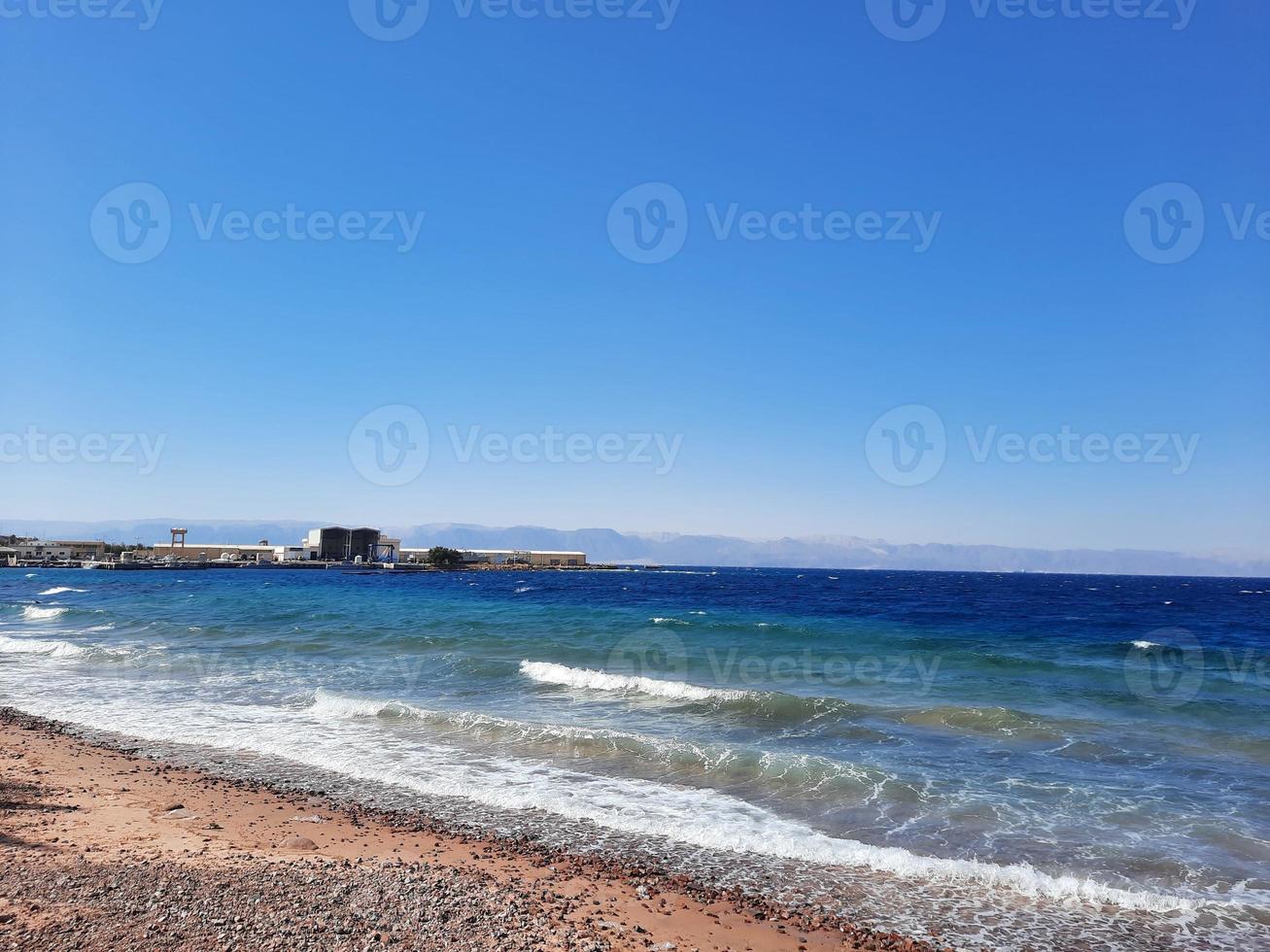 The mesmerizing view of the deep blue waters of Haql Beach in Saudi Arabia. photo