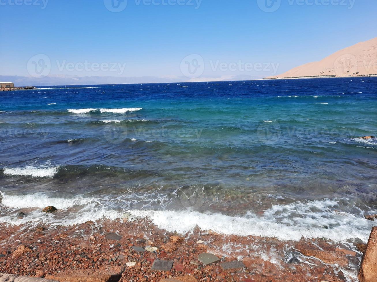 The mesmerizing view of the deep blue waters of Haql Beach in Saudi Arabia. photo