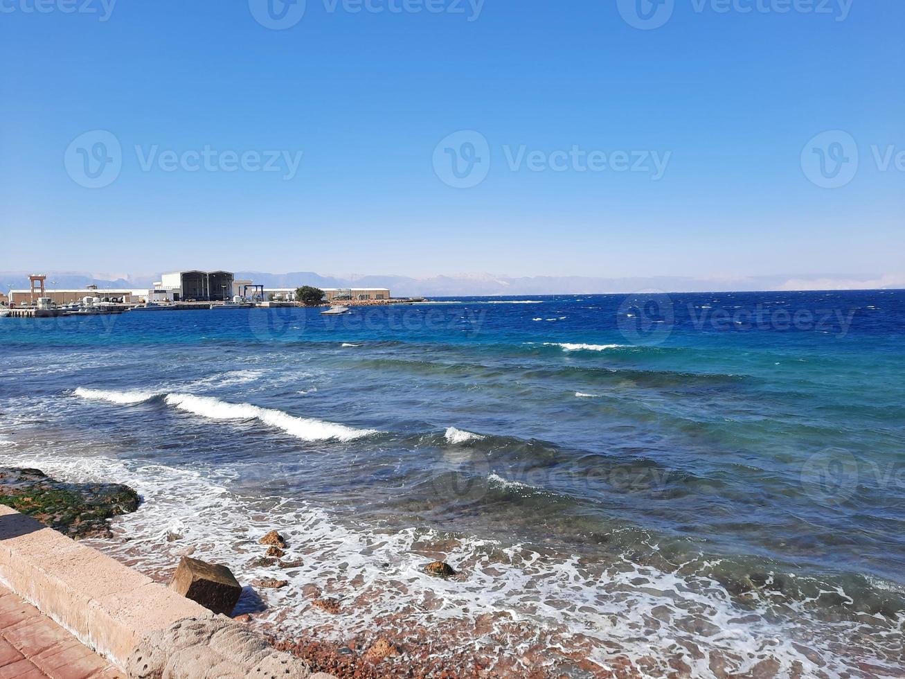 The mesmerizing view of the deep blue waters of Haql Beach in Saudi Arabia. photo