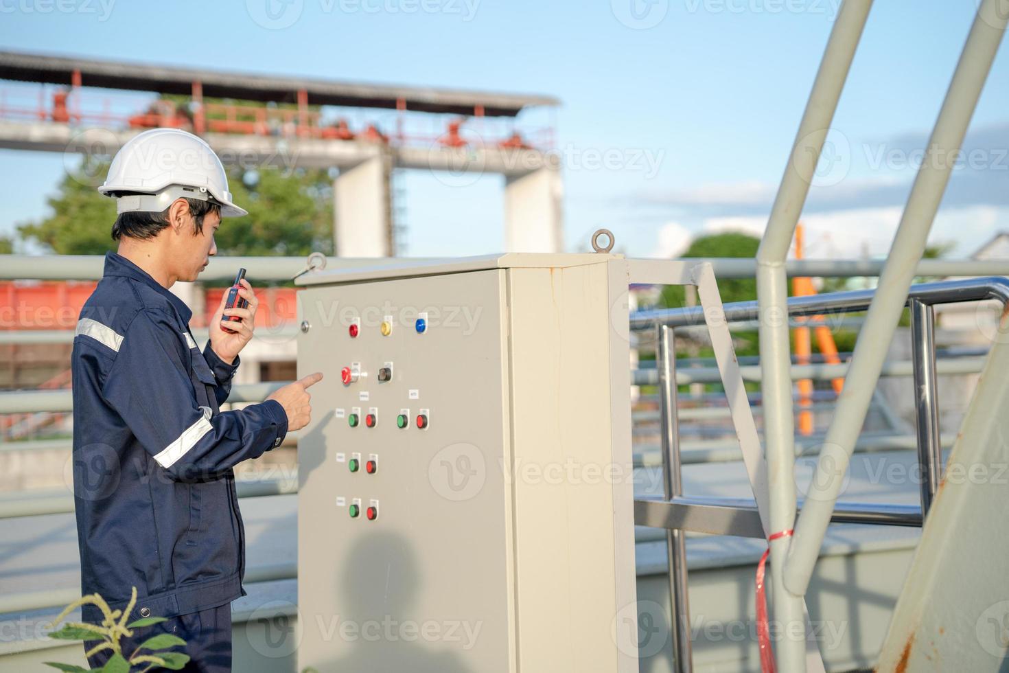 Mechanic or maintenance or electrical engineer checking main electrical control systems industrial plant. Utility fore man daily check power systems in process. Main Distribution Board, Switchboards photo