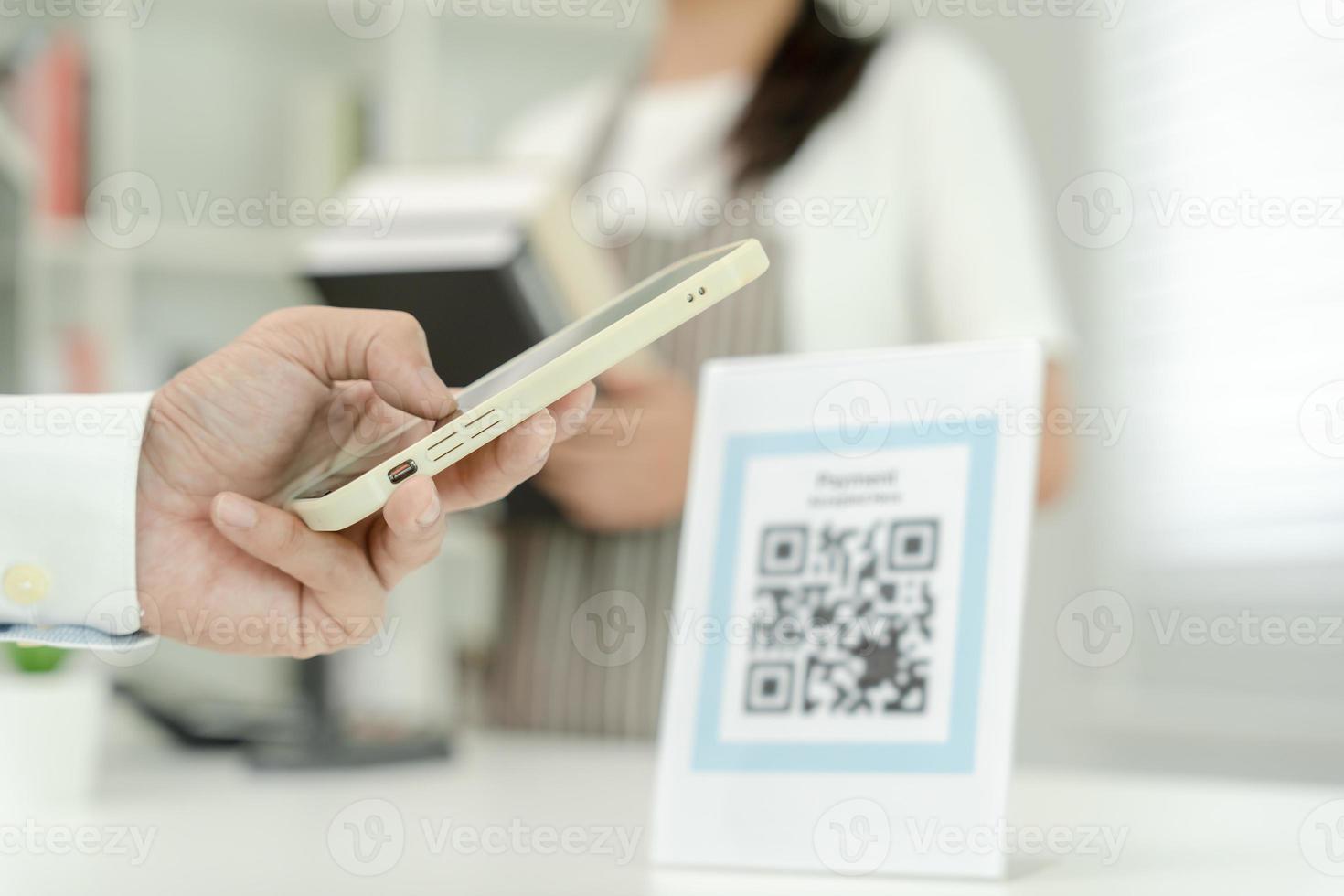 Customer use smartphones to scan QR codes to pay in-store with digital payments without cash. scanning get discounts. E wallet, technology, online payment, banking app, smart city, money transfer. photo