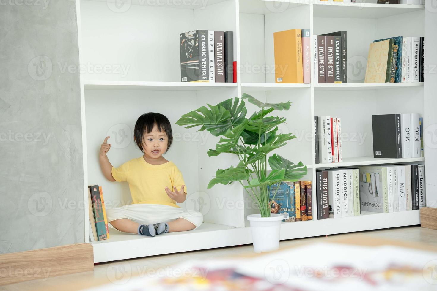 little girl playing hide and seek family is happy and excited in the house. daughter having fun spending time together. Holiday, Activity, Executive Function, intelligence quotient, emotional quotient photo