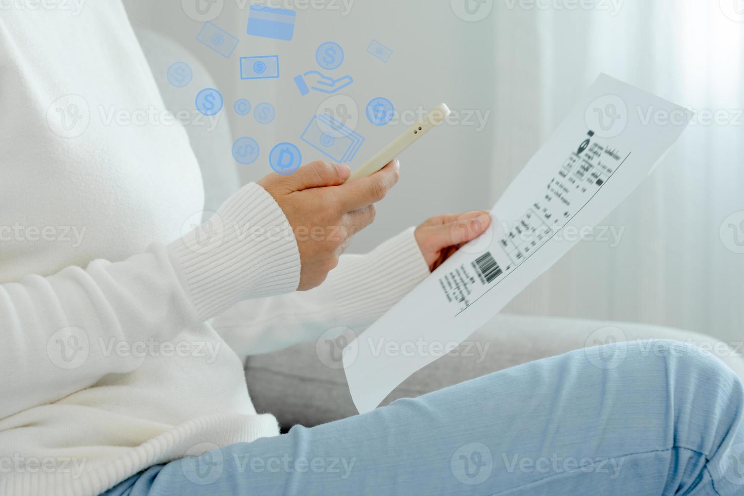 Modern woman use phone to scan barcode or QR codes to pay credit card bill after receiving document invoice online. payment, receive, paying electricity, digital payments without money, technology photo