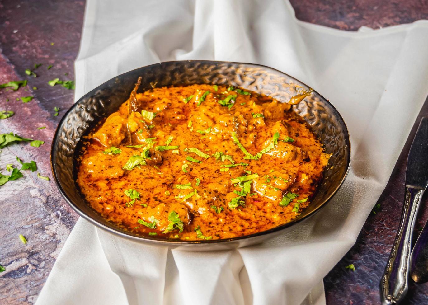 Spicy Indian chicken curry served with coriander. photo