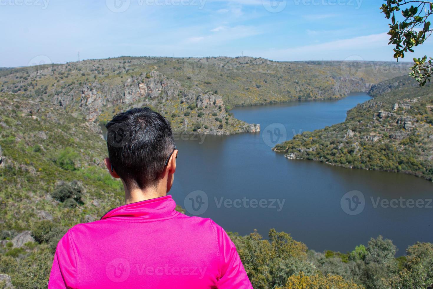 portrait of woman on her back looking at the river in the valley photo