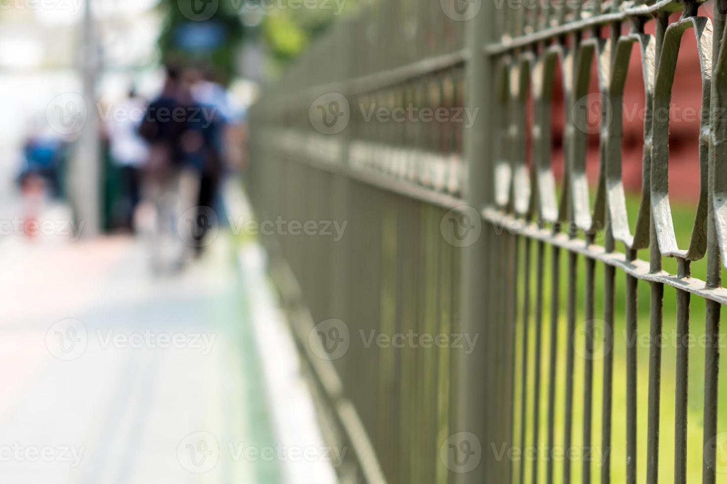 Wrought iron fence beside a street in the city photo