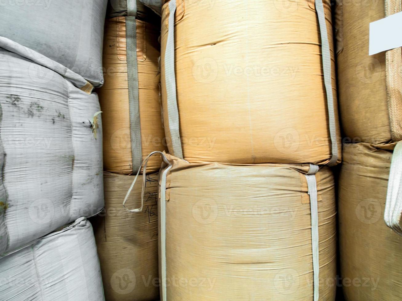 Raw material in the big woven plastic bag photo