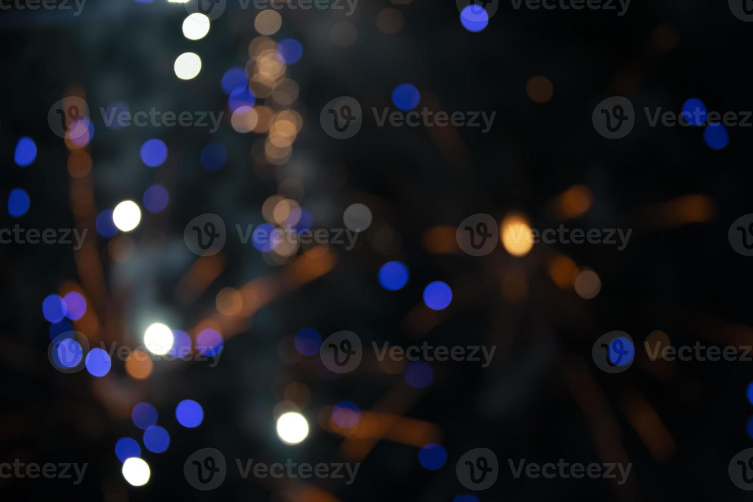 On a black background bokeh from explosions of colorful fireworks. photo