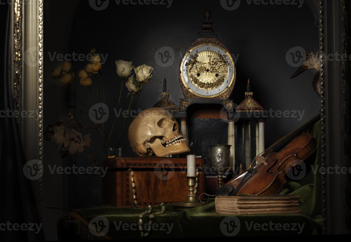 Close-up still life, Dutch painting of the 17th century. On the table on a black background are flowers, a skull, a clock, a violin, keys. Things that tell about a person's life. photo