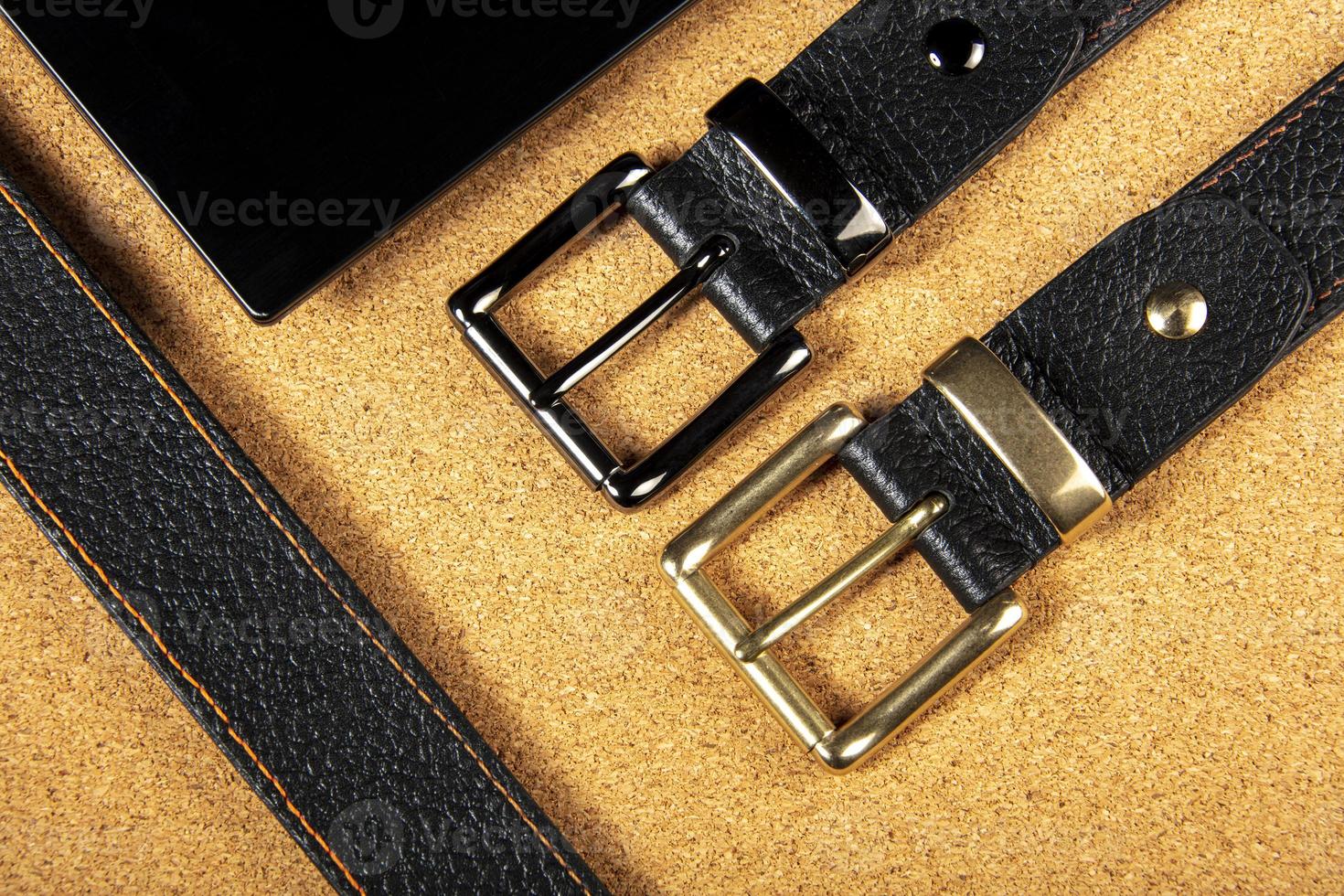 Part of leather belts with metal buckles. photo