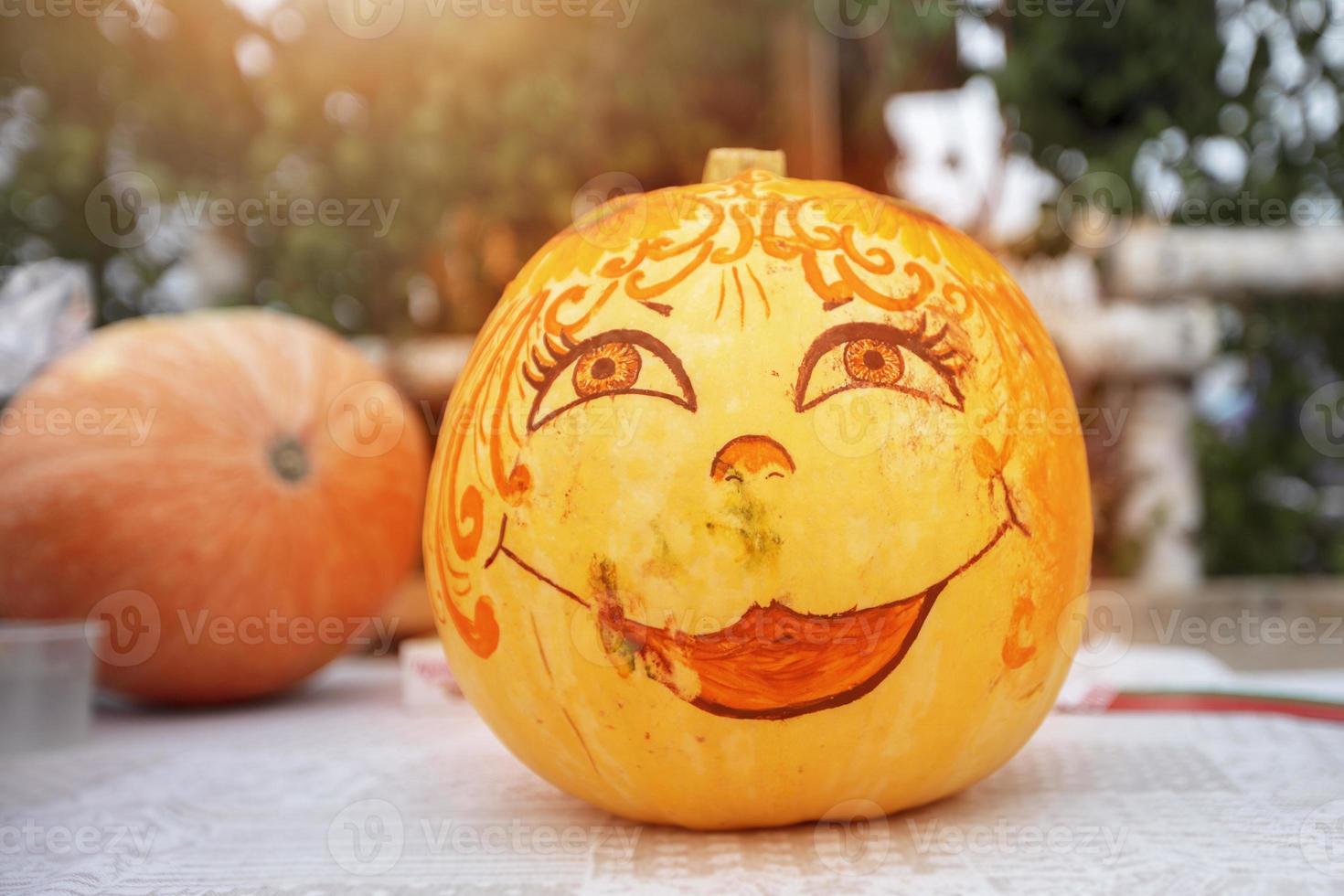 Creative halloween pumpkin with kind and cute makeup photo