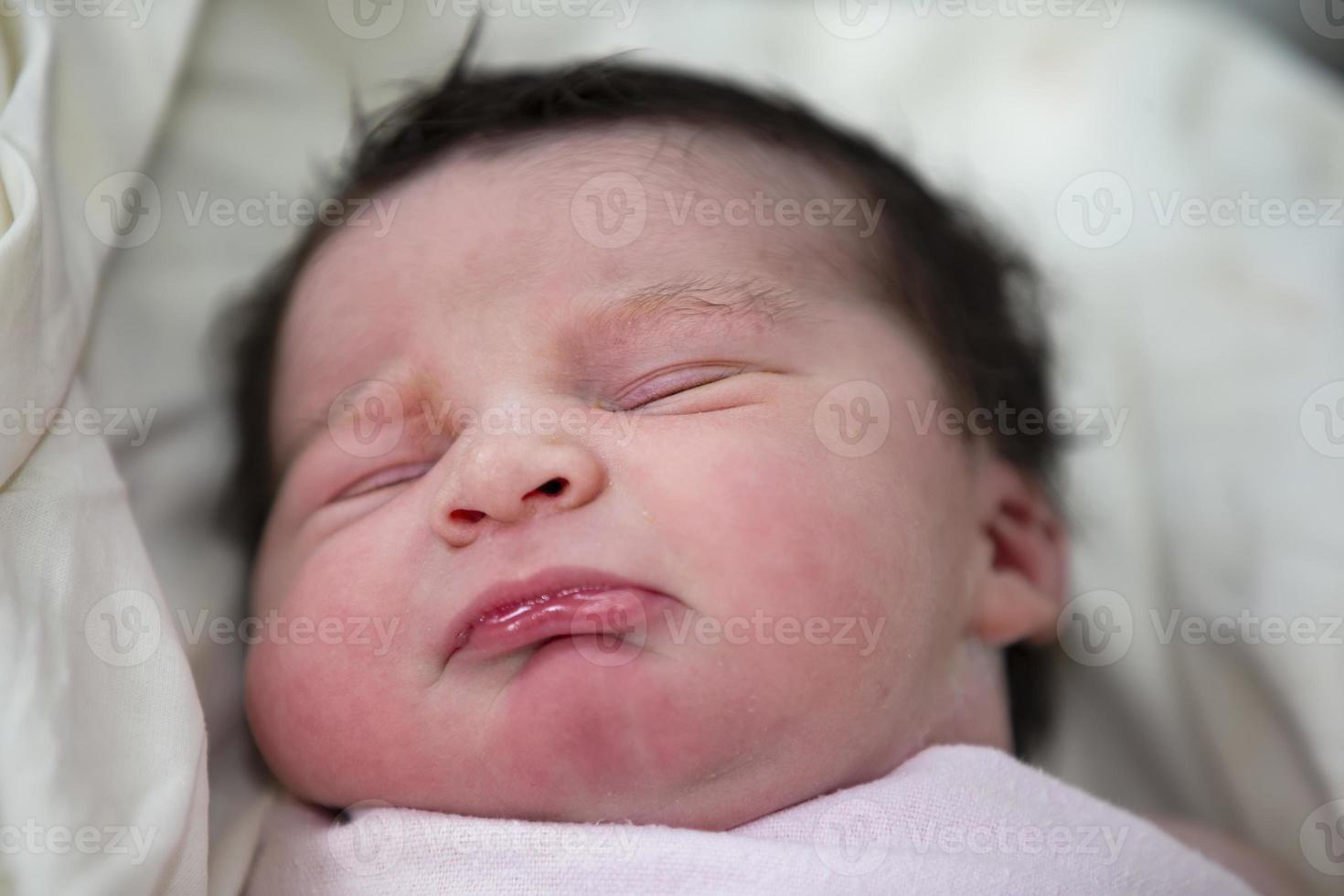 Close-up of the face of a newborn baby. photo