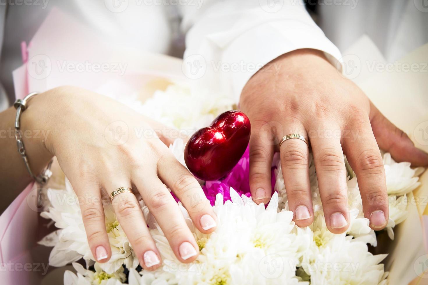 Hands of lovers with wedding rings. Wedding day of a heterogeneous couple. photo