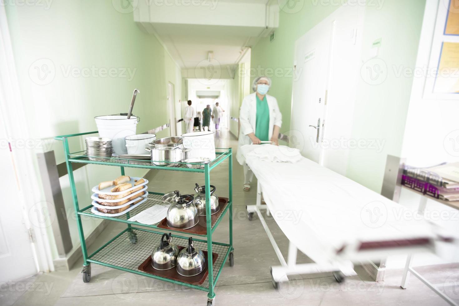 In the hallway of the hospital is a cart with food for the sick. photo