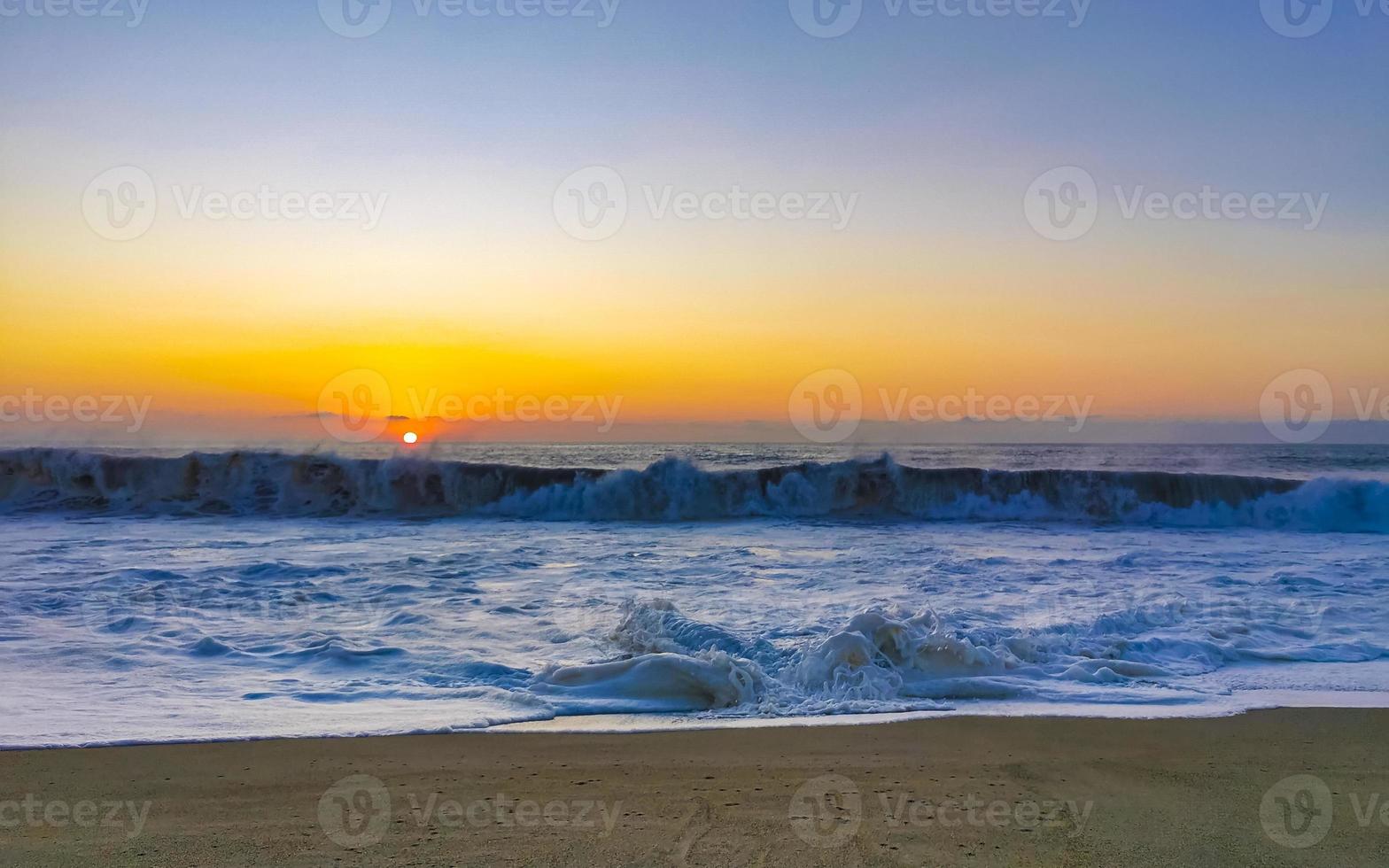 Colorful golden sunset big wave and beach Puerto Escondido Mexico. photo