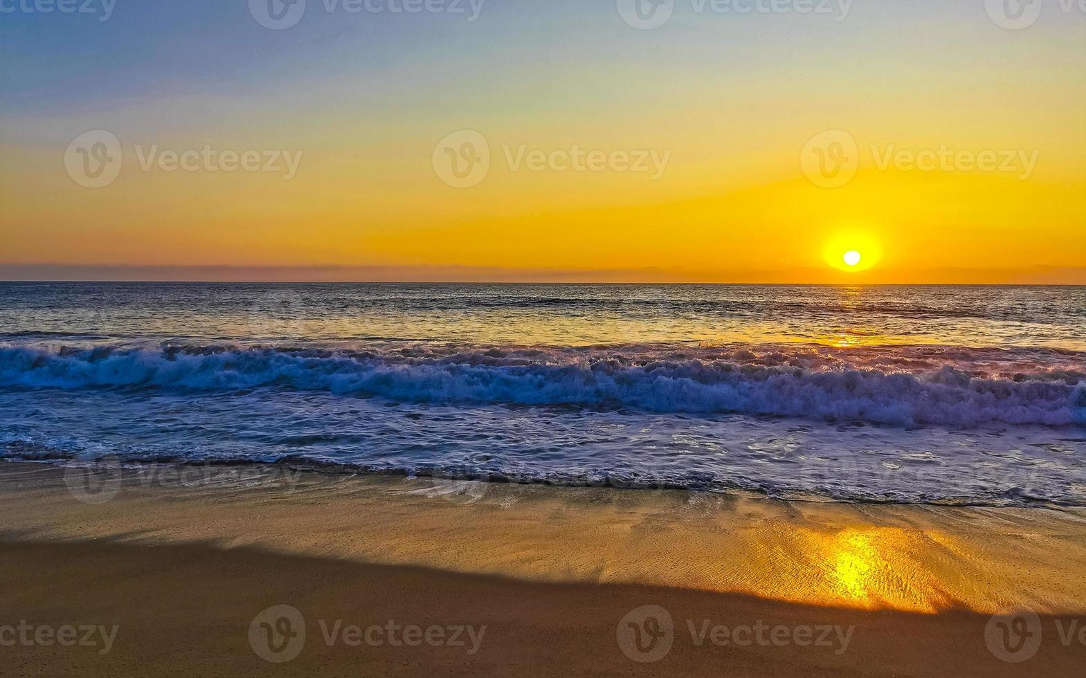 Colorful golden sunset big wave and beach Puerto Escondido Mexico. photo