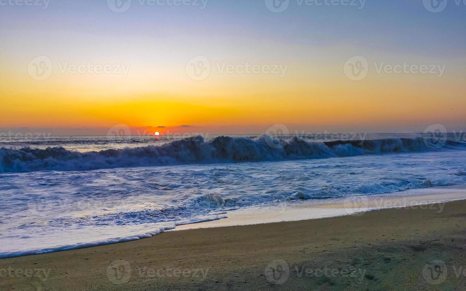 Colorful golden sunset big wave and beach Puerto Escondido Mexico. photo