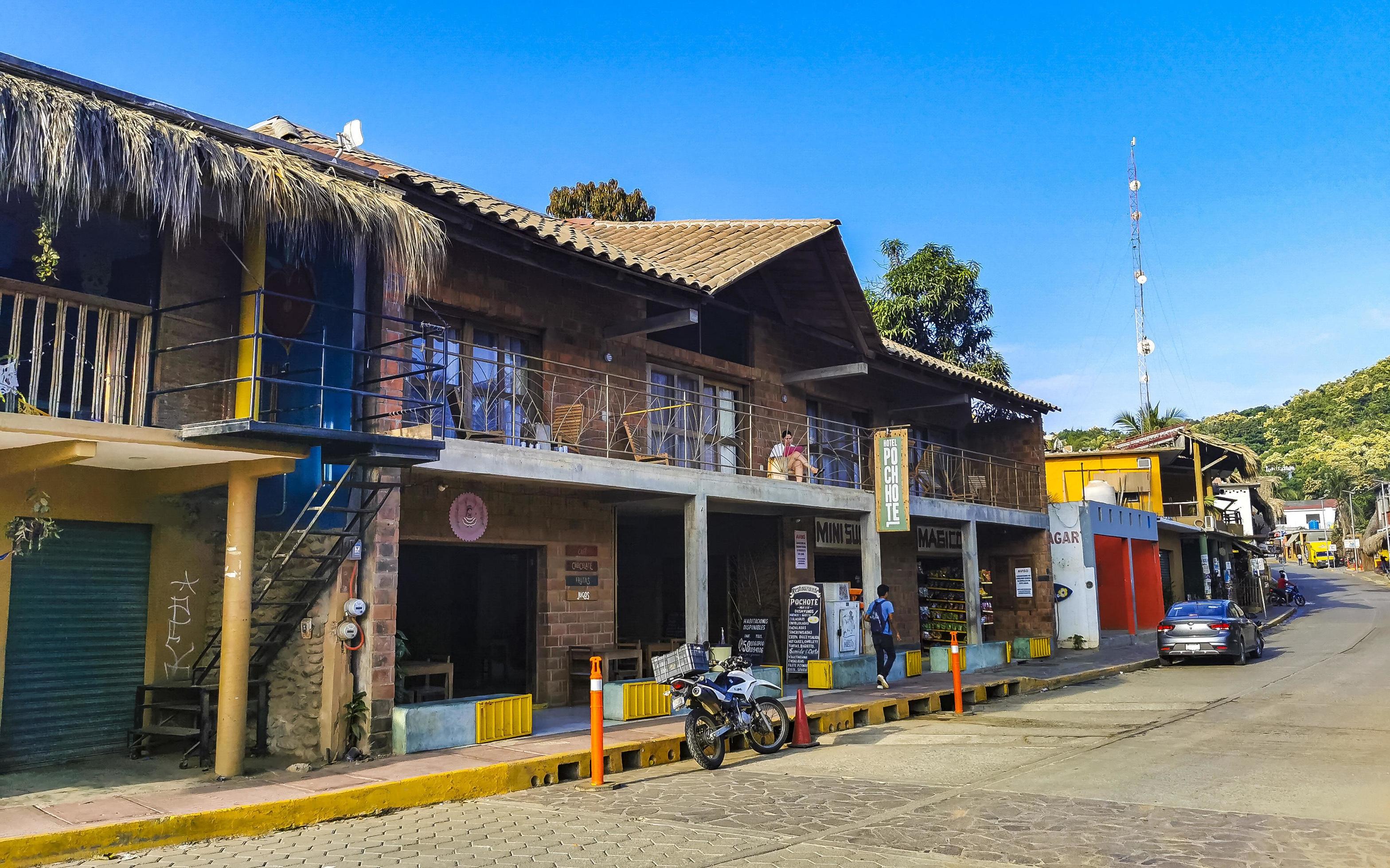 Mazunte Mexico Hotels; Mazunte Oaxaca Mexico 2022 Idyllic street houses people cars hotels