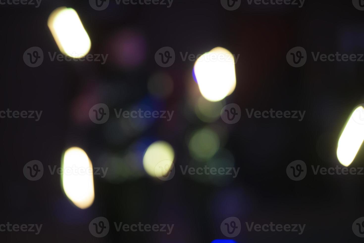 White bokeh spots on a dark background of a night city. photo