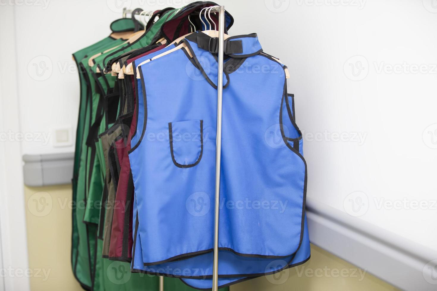 Rack of lead aprons used for x-ray protection in operating room, hospital photo