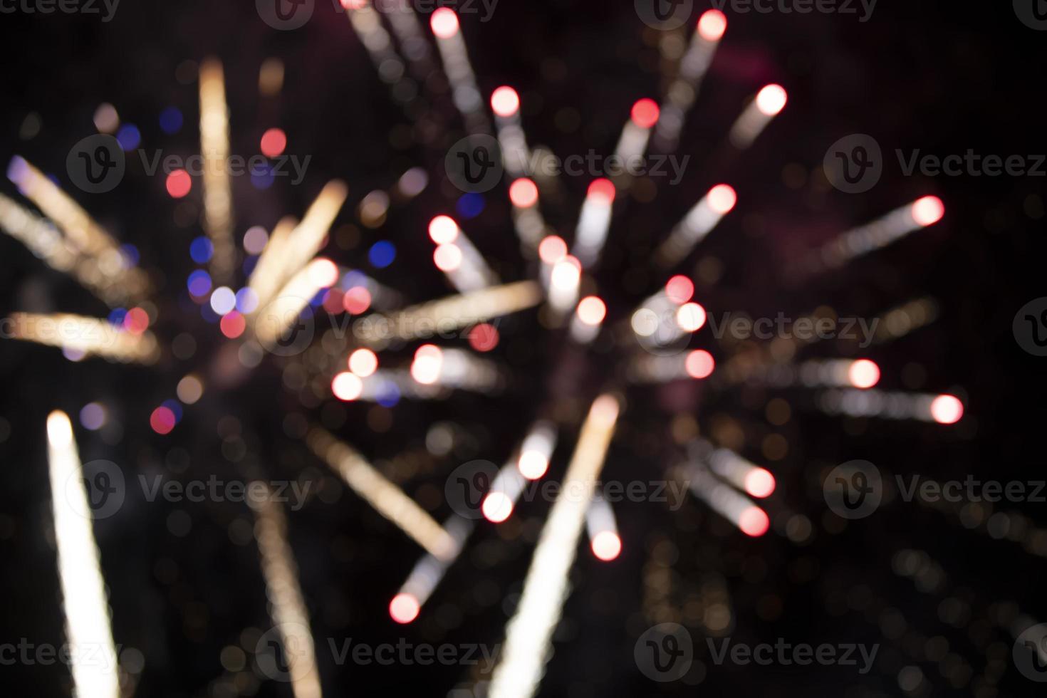 On a black background bokeh from explosions of colorful fireworks. photo